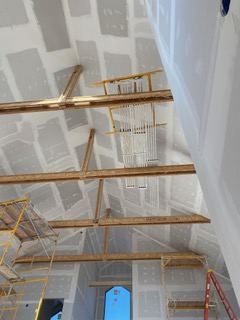 Drywall hung across a vaulted ceiling and walls in a Black Hills, SD new construction home