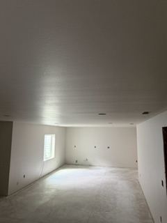 Finished and painted interior room with smooth drywall walls and ceiling